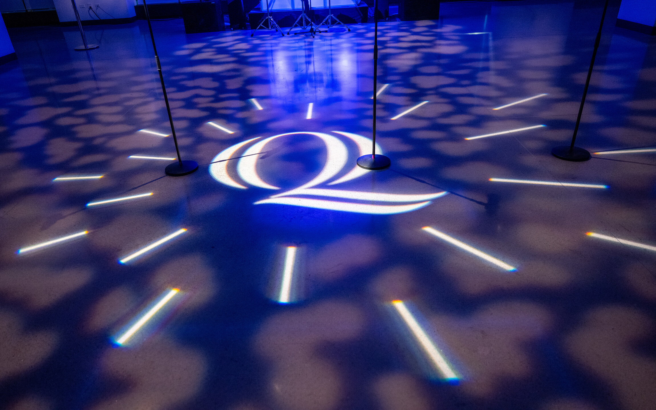 Image of the Quinnipiac "Q" projected on the dance floor during the Gala.